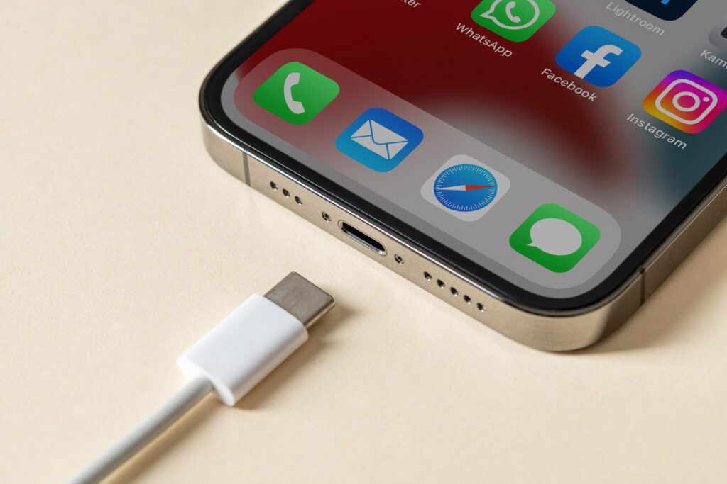 Apple iPhone in titanium finish with USB C port and cable